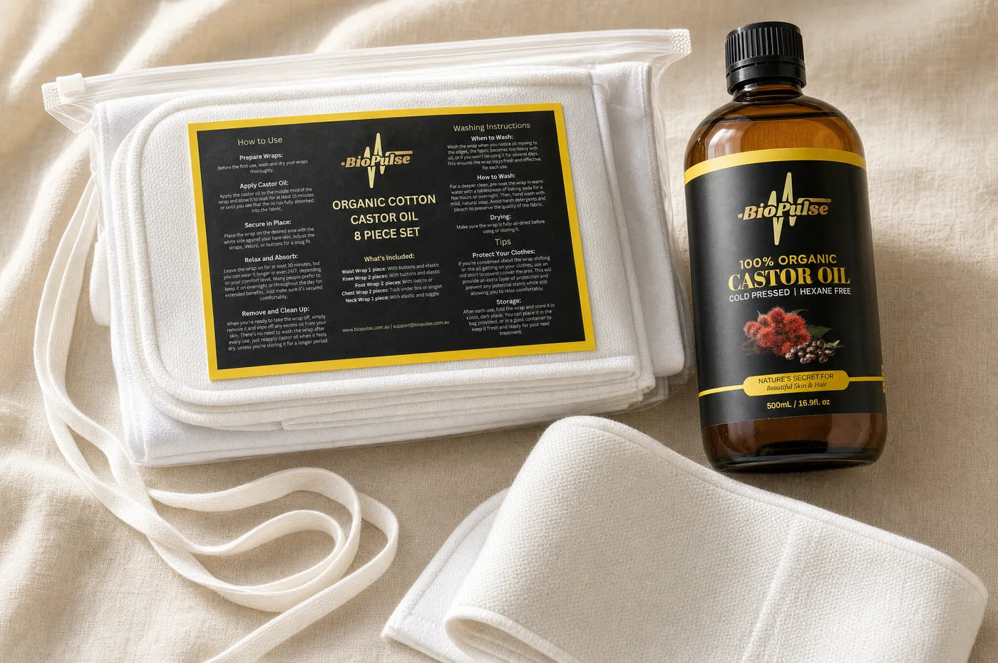 The BioPulse organic cotton wrap set laid out with the castor oil bottle