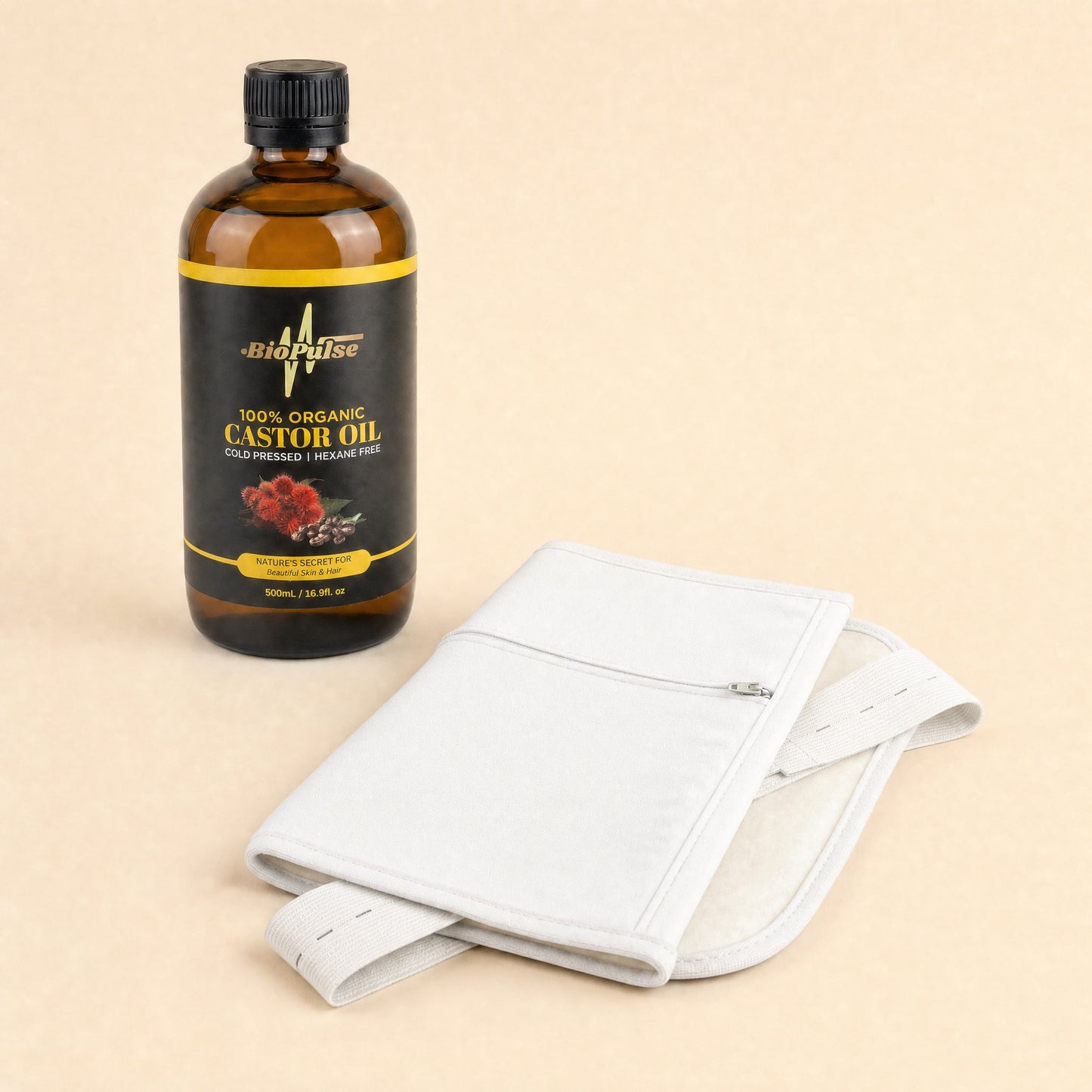 BioPulse 500mL Organic Castor Oil bottle beside a folded white cotton waist wrap with elastic straps