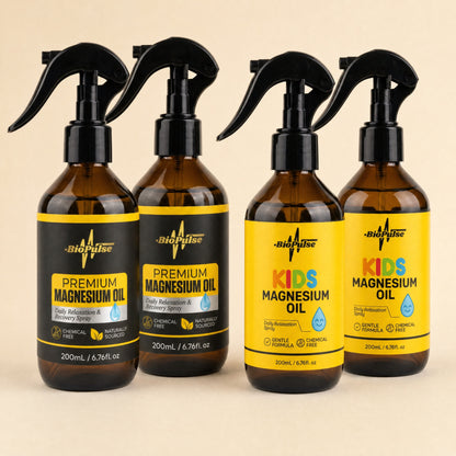 Two BioPulse Premium Magnesium Oil 200mL sprays beside two Kids Magnesium Oil 200mL sprays in amber glass