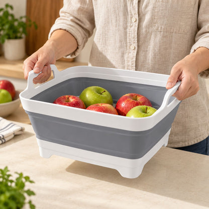 A person holding FreshDip Fold by both carry handles with produce inside.