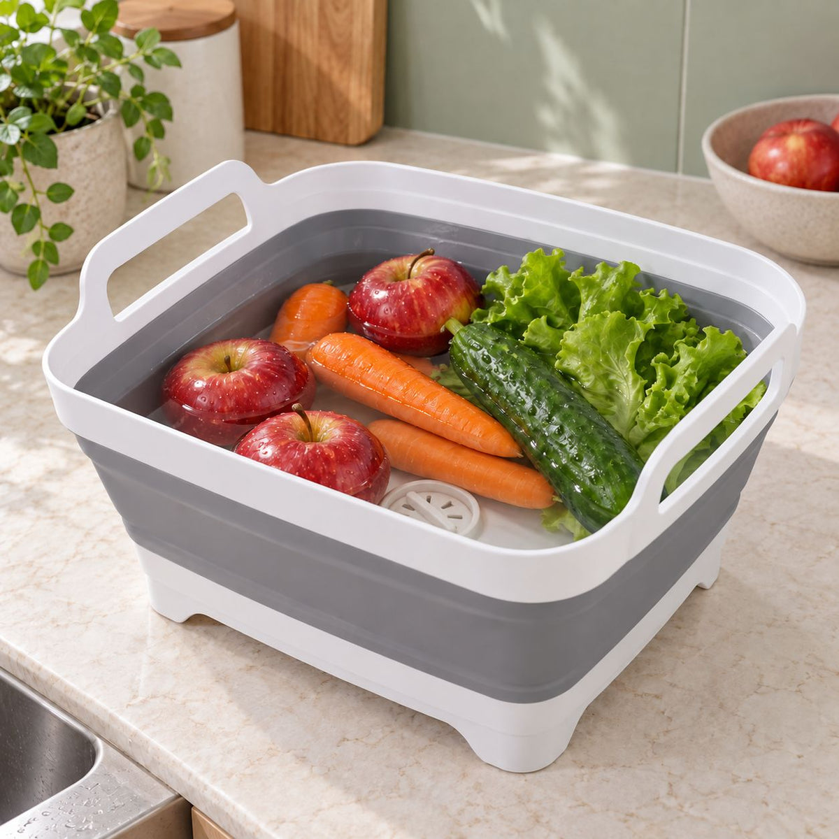 FreshDip Fold holding fruit and vegetables in water on a kitchen bench.