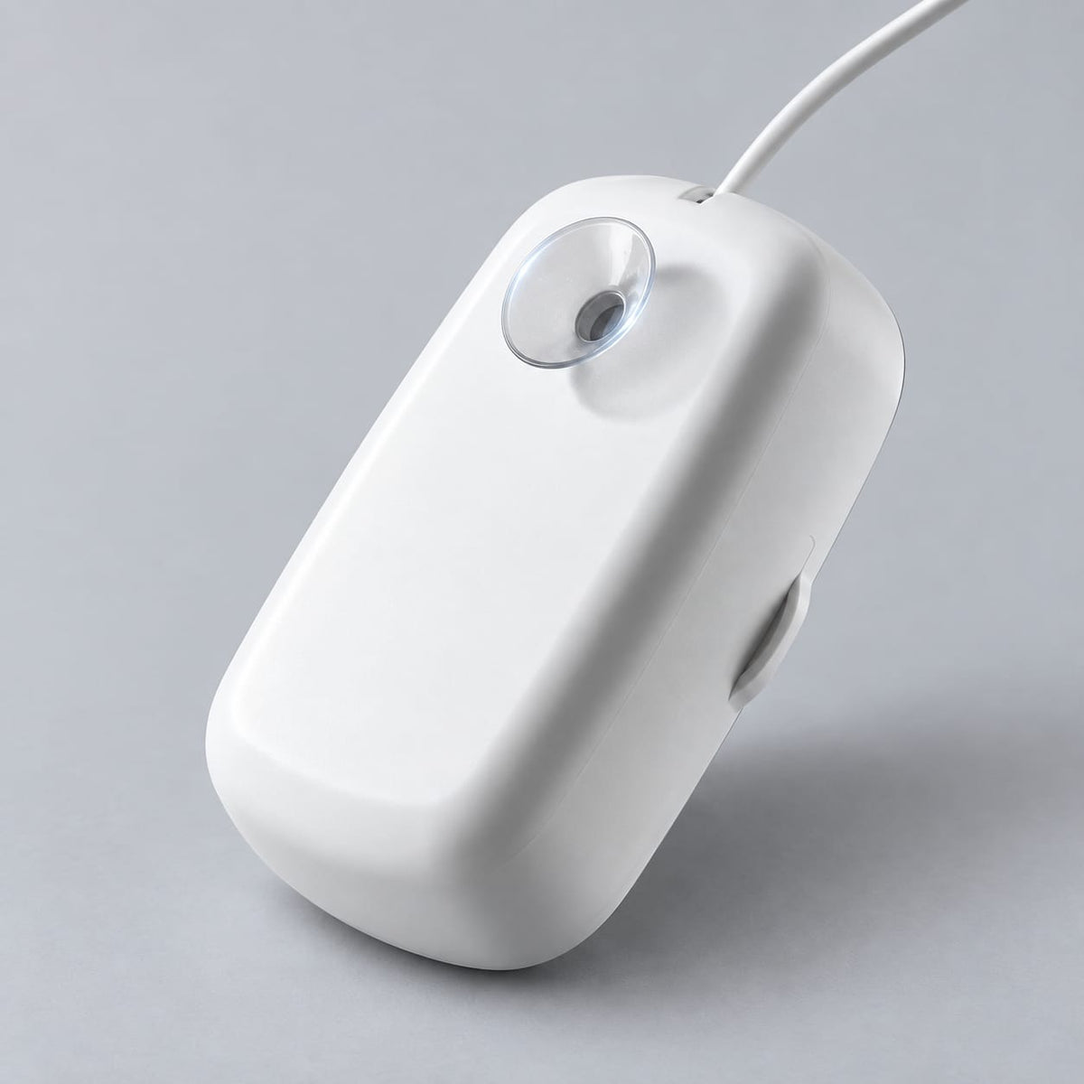 Rear view of the white FreshDip cleaner showing its suction cup and attached cable.
