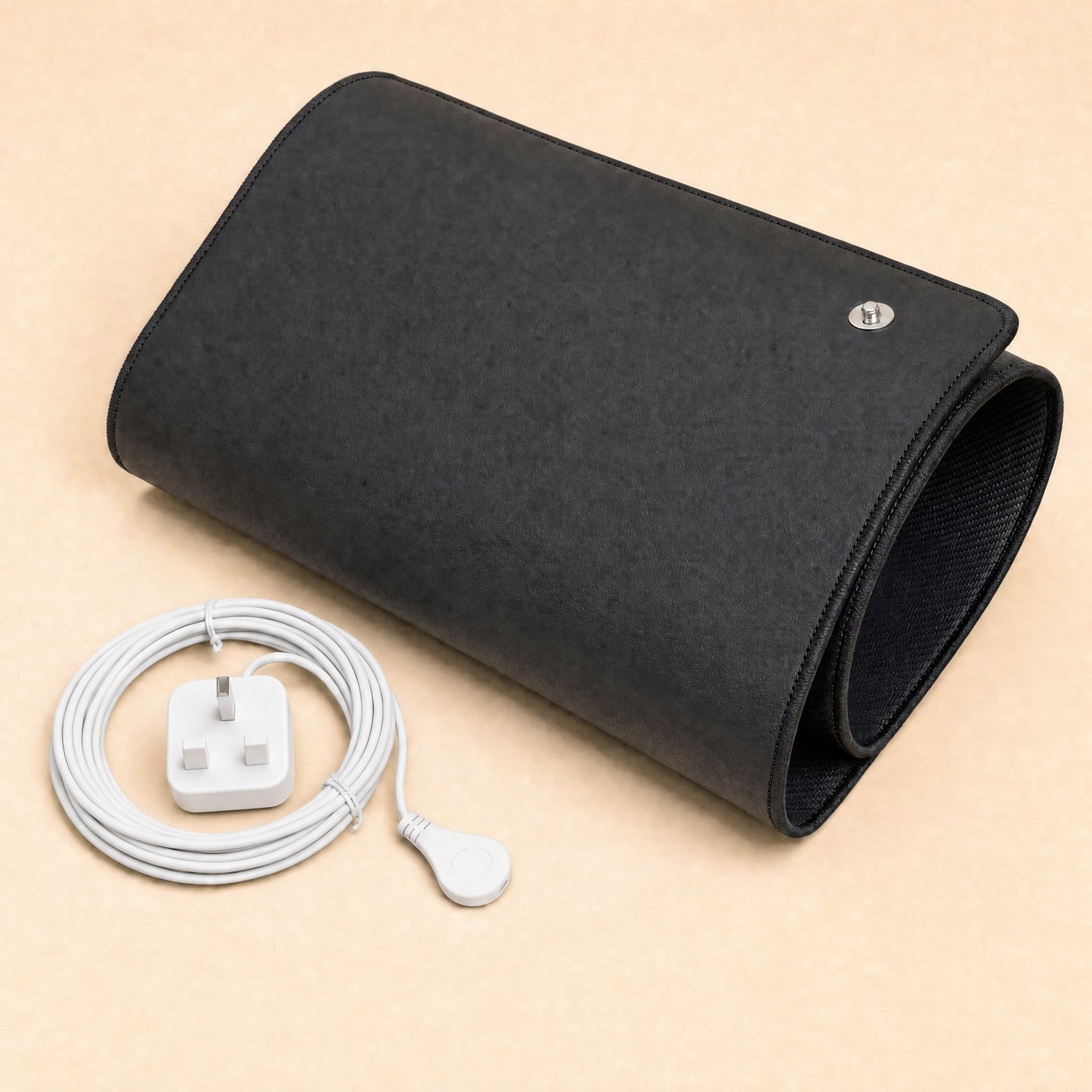 BioPulse Earthing Mat rolled up in black with a coiled white cord and UK-style plug