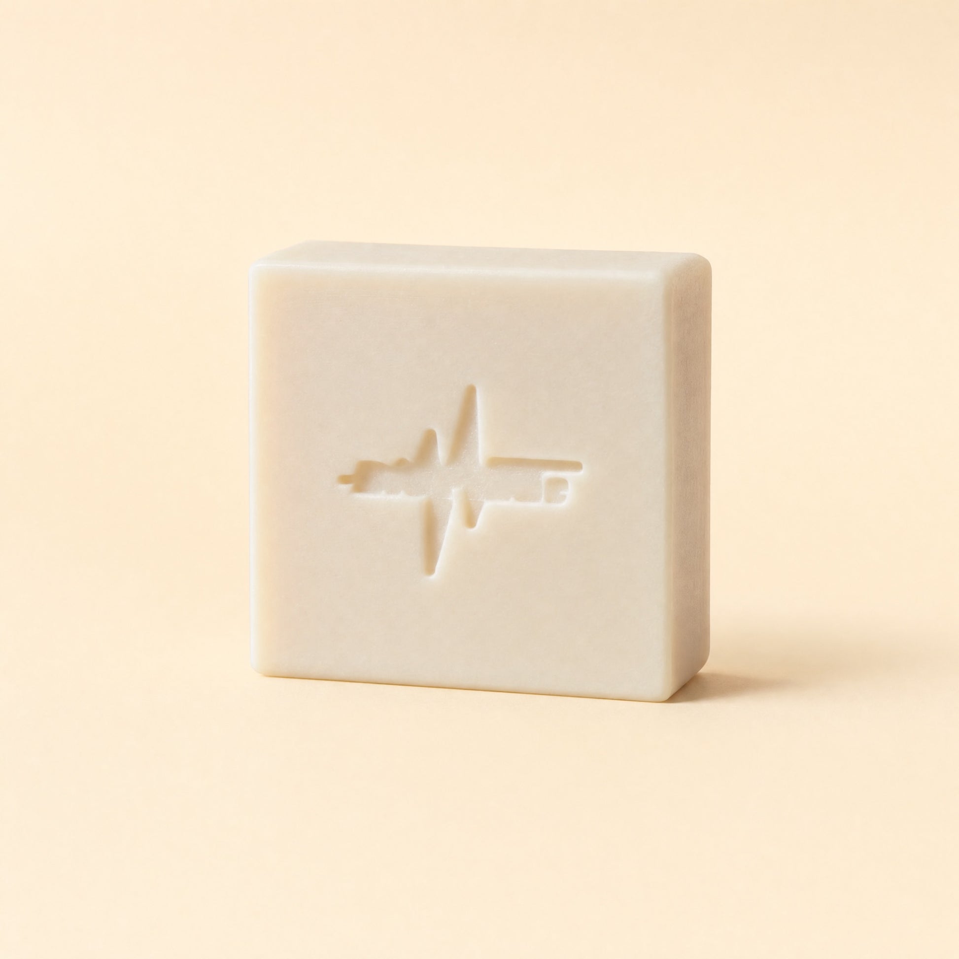 BioPulse Organic Tallow Soap plain cream bar with the pulse logo stamp on a cream background